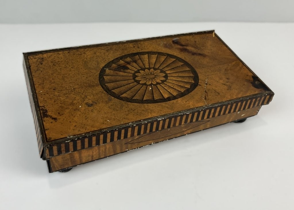 1920s Cadbury Chocolate Commemorative Tin Box: Collectible 1920s chocolate tin was produced by the Cadbury Chocolate Company of England to celebrate three British monarchs. The lithographed metal box is styled to resemble fine English furniture,
