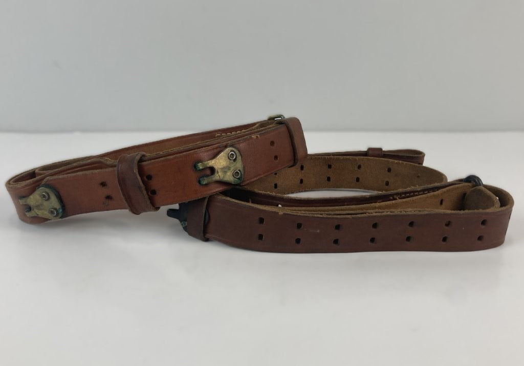 Military Leather Slings Featuring George Lawrence: These two supple brown leather military slings includes a notable example crafted by the legendary Portland, Oregon leather goods manufacturer The George Lawrence Company, which was founded in 1857.