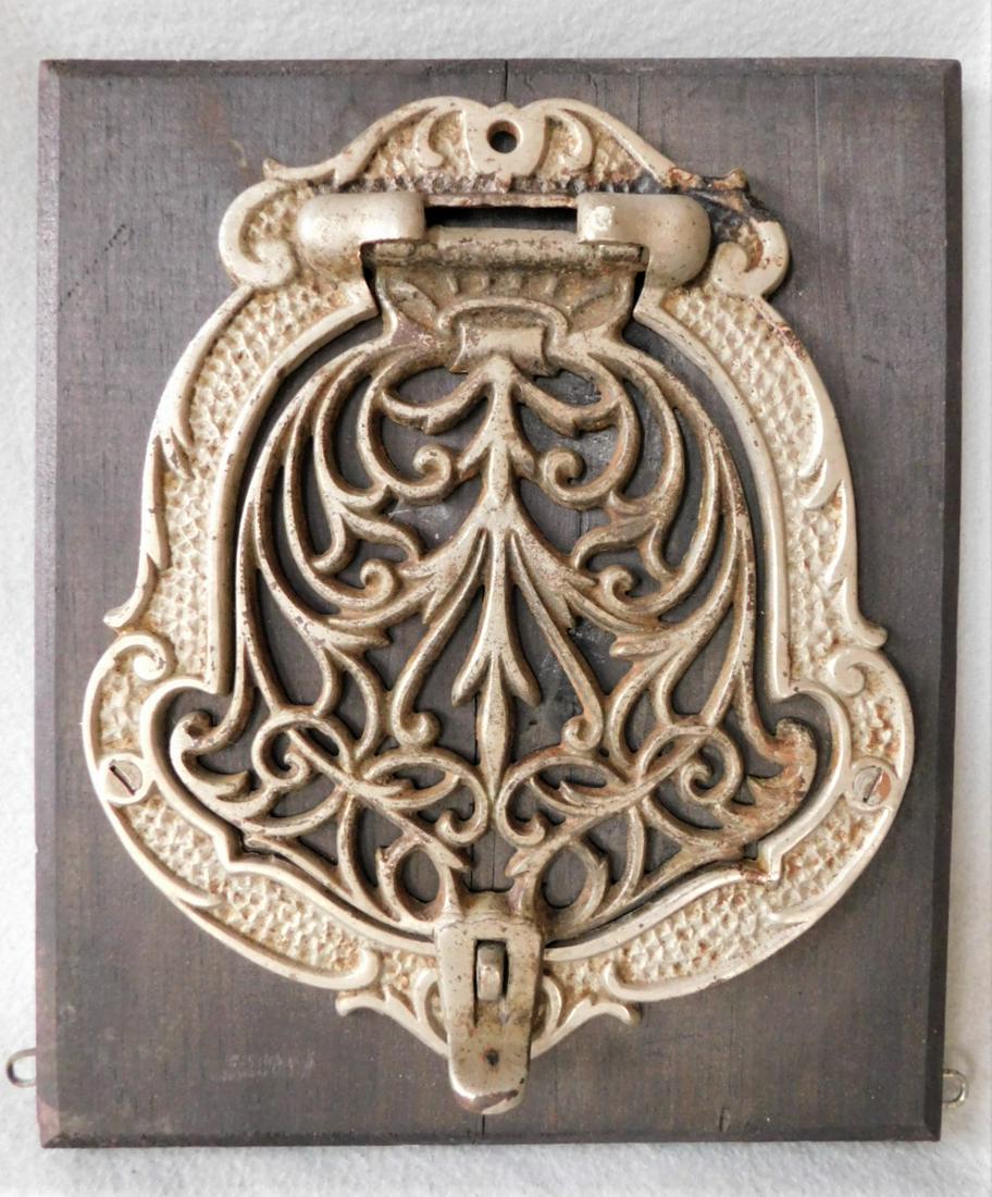 Ornate Iron Door Knocker: Ornate Iron Door Knocker in VG Cond. on Wood Panel - 9 1/2in.H. x 8in.W.
