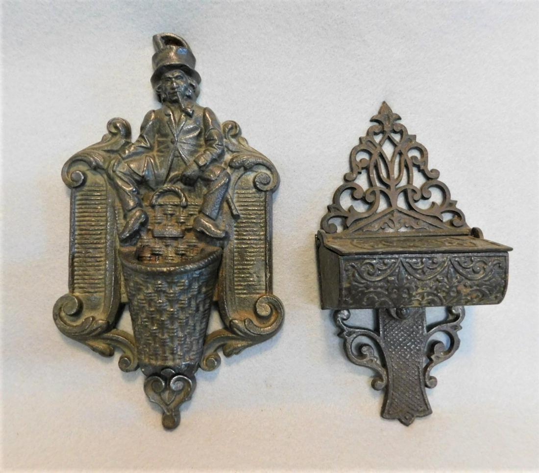 Lot of 2 Early Iron Figural Matchsafes: Lot of 2 Early Iron Figural Matchsafes incl. a Repousse Figural w/Sitting Leprechaun w/Pipe - 9in.H. x 5in.W.; Ornate Lidded Pc. - 8 in.H. x 4in.W.