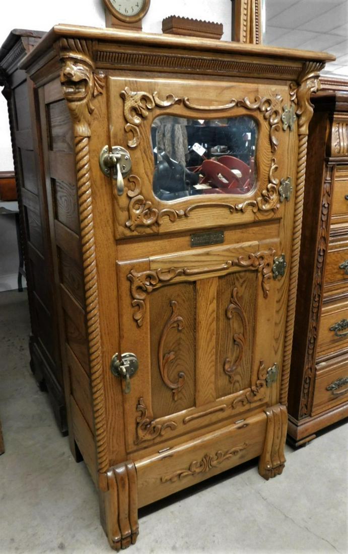 Heavily Carved Oak Ice Box: Heavily Carved Oak Ice Box w/Twist Columns, Claw Ft., Mirror Dr. & Lion's Heads Marked on Plate "North Pole" in VG Cond. - 50in.H. x 27 1/4in.W.