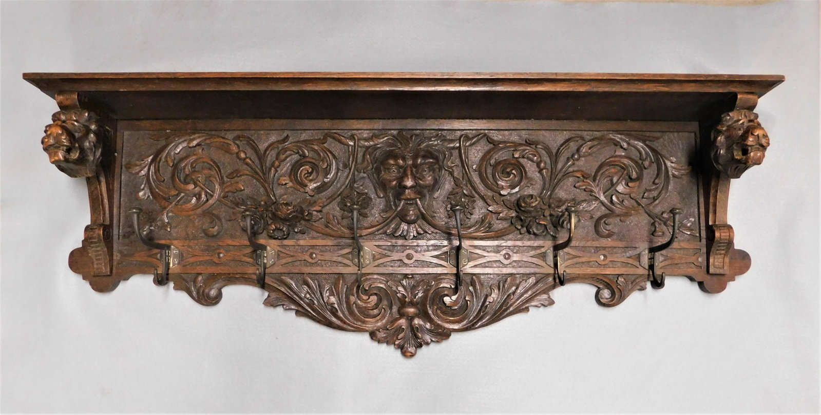 Heavily Carved Oak Wall Coat & Hat Shelf: Heavily Carved Oak Wall Coat & Hat Shelf w/Figural Face, Lion's Heads & Floral Carvings in VG Cond. - 15in.Hx 39 1/2in.L