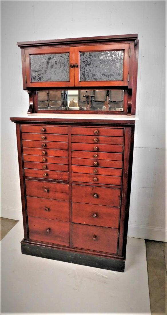 C.1900 Mahogany Dental Cabinet: C.1900 Mahogany 20 Drwr. Dental Cabinet w/Dbl. Dr. & Milk GlassTop, Milk Glass Drwr. Inserts w/Unique Bakelite Pulls in VG Cond. - 32in.W.x62in.H.x12in.D.