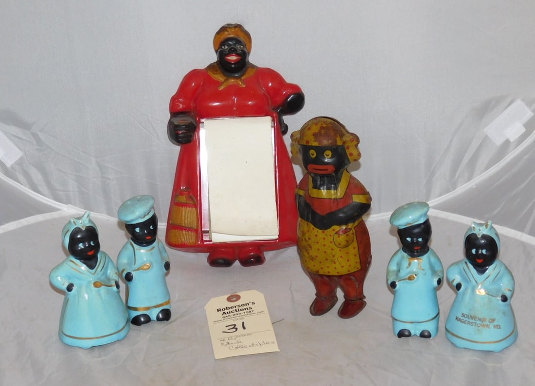 4 Black Vintage Collectible Pcs.: 4 Black Vintage Collectible Pcs. Incl. 8"H Tin "Lindstrom" Windup Mammy Toy; 5 1/2"H 2 Prs. S/P Shakers; 10 1/2" H Plastic Mammy Wall Pad in Gd Cond.