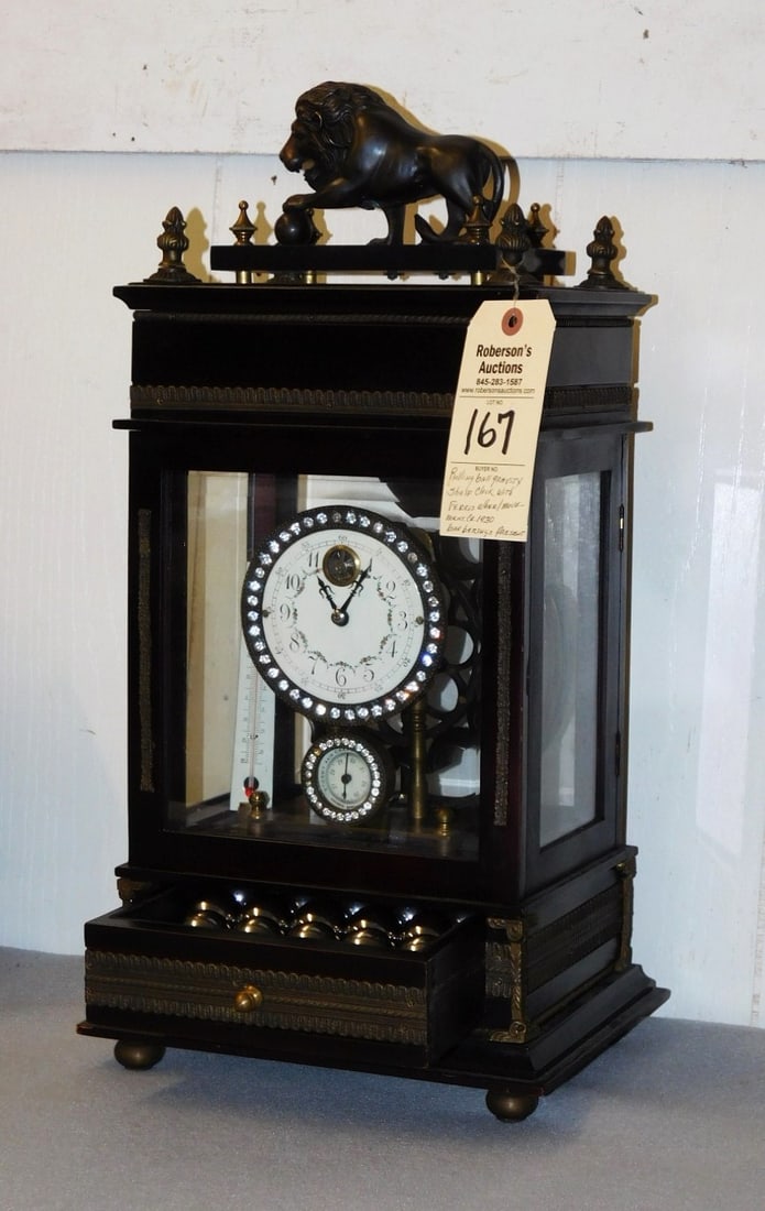 Rolling Ball Gravity Shelf Clock: Rolling Ball Gravity Shelf Clock w/ Ferris Wheel Movement C. 1930 - Ball Bearings Present in Gd Cond. - 22"H x 10 3/4"W x 8 1/2"D Please Note: We will not be shipping Firearms & Clocks, Shipping for F