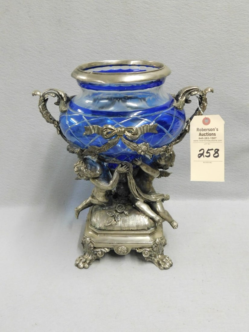 Silverplated Etched Blue Glass Jardinere: Silverplated Etched Blue Glass Jardinere w/Dbl. Cupid Base, Ribbons & Floral Decorations, Feathered Handles in Gd Cond. - 15 1/2"H x 8"Sq. Base