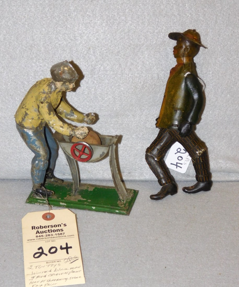 2 Vintage Tin Toys of Men: 2 Vintage Tin Toys of Men Incl. Jtd. Black Man w/ Good Orig. Paint & A Man at a Sharpening Stone in Fair Paint (As Found) Blk. Man - 8 1/2"H.; Man at Stone 6 1/2"H.