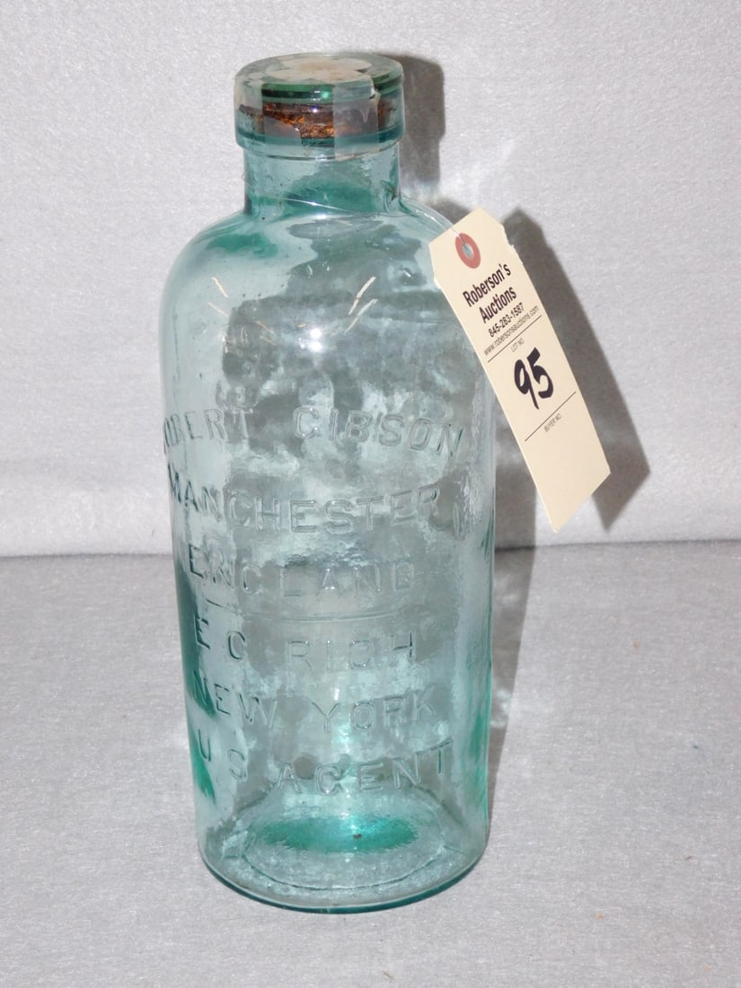 Early Advertising Bottle: Early Lg. Advertising Bottle Marked "Robert Gibson-Manchester England EC Rich NY US Agent" in VG Cond. (Glass/Cork Stopper. 13 1/2"H x 4 1/2" Base