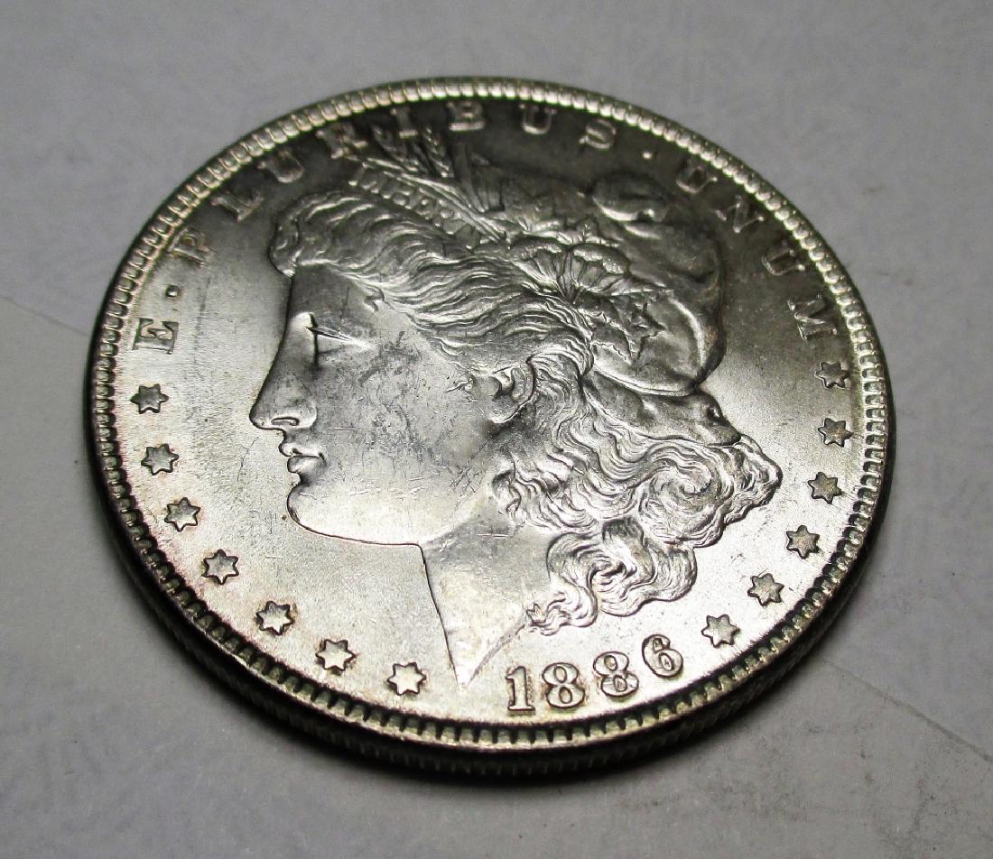 1886 P High Grade Morgan Silver Dollar: Please note that all items are as shown in image. Bidder is responsible for all grade based upon images and value. Bidder further agrees to all terms and understands all nuances of bidder registration