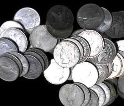 Lot of 25 Assorted Pre 1935 US Silver Dollars: A lot with 25 mixed type US Silver dollars! Peace and or Morgans- g-au grades. No holed coins.