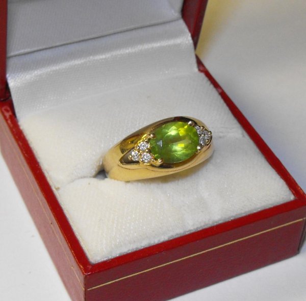 10k YG Peridot & Diamond Ring: A East/West Mount peridot ring with diamond accent
