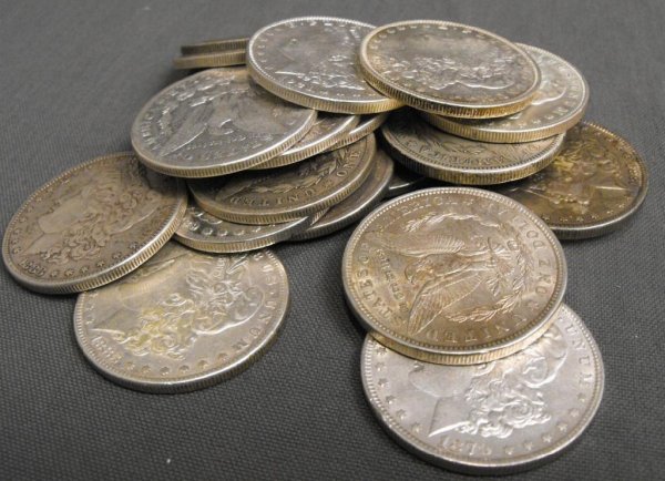 Lot of 20 Morgan Silver Dollars: A lot with 20 Morgan Silver Dollars- g-au grades, unsearched lot of Morgans.All of our lots are US Asset Forfeiture & Seizures Acquisitions. Fresh to the market items, non auction circuit merchandise.