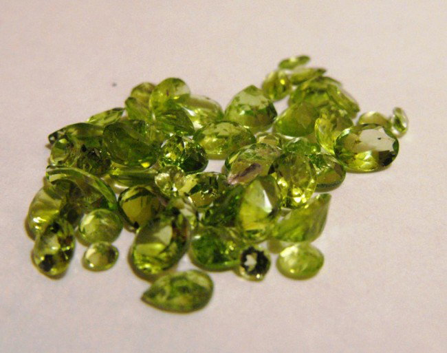 25 ct. Peridot Gemstone Parcel: All of our evaluations use some or all of the following Gemological tools. : A fully corrected triplet loupe, binocular microscope, master color comparison diamond set, electronic carat balancing scal