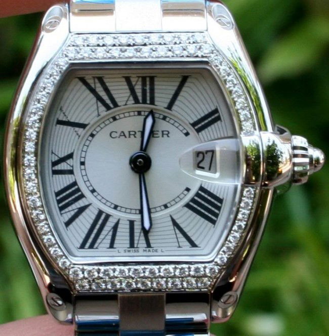 WAS CARTIER LADIES AUTHENTIC STEEL ROADSTER DIAMOND: THIS WATCH IS CONSIDERED A BRAND NEW UNWORN 100% AUTHENTIC LADIES STAINLESS STEEL CARTIER ROADSTER.THE REAL DIAMONDS THAT ARE VS CLARITY AND F COLOR DIAMONDS--THAT CARTIER DID NOT INSTALL--THE REST OF