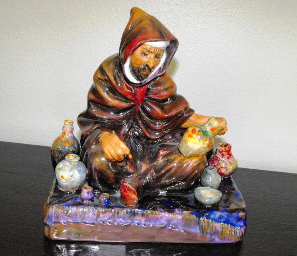 Royal Doulton Flambe The Potter Figure: A fine example of true Royal decorative porcelain. The Royal Doulton Company is an English company producing tableware and collectables, dating to 1815. Operating originally in London, its reputation 