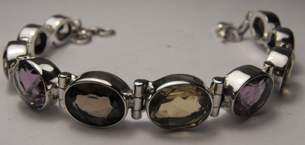 31.25 tcw Mixed Colored Gem Bracelet- $ 875 GG: Topaz-Blue Topaz-Amethyst-Lemon- This item was appraised with the gemstone in mount. Each gemstone has been evaluated on a case by case basis, some stones are higher quality than others and will be mo