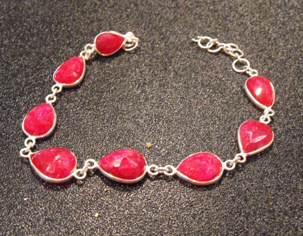 60 tcw PLUS Ruby and Sterling Bracelet: Item is exact item in photo. Please use the photo to determine grade and value for yourself.