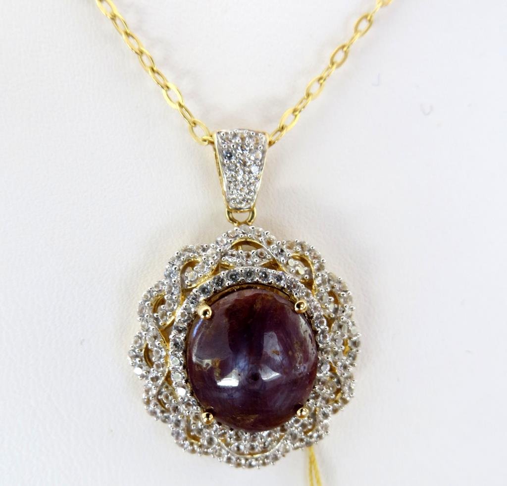 J-7 $ 6,443 App. Ruby & Sapphire Pendant: 12.36 ct Natural Cabachon Ruby set with 1.86 ct white sapphire set in sterling silver with gold overlay.