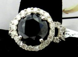 $15,290 App. Black & White Diamond Ring: 6.11 ct center stone black diamond with 1/14 ct bright white diamond accents. Set in 14k gold mount. See appraisal for further information. Please review the appraisal type and purpose.