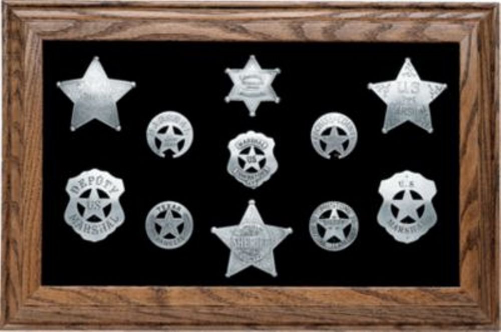Lawman Badge Display Framed: A nice reproduction badge presentation in frame. These 11 silver-plated replica badges include Tombstone Sheriff, U.S. Marshall and Texas Ranger among many others. The badges have a hand-applied tarni