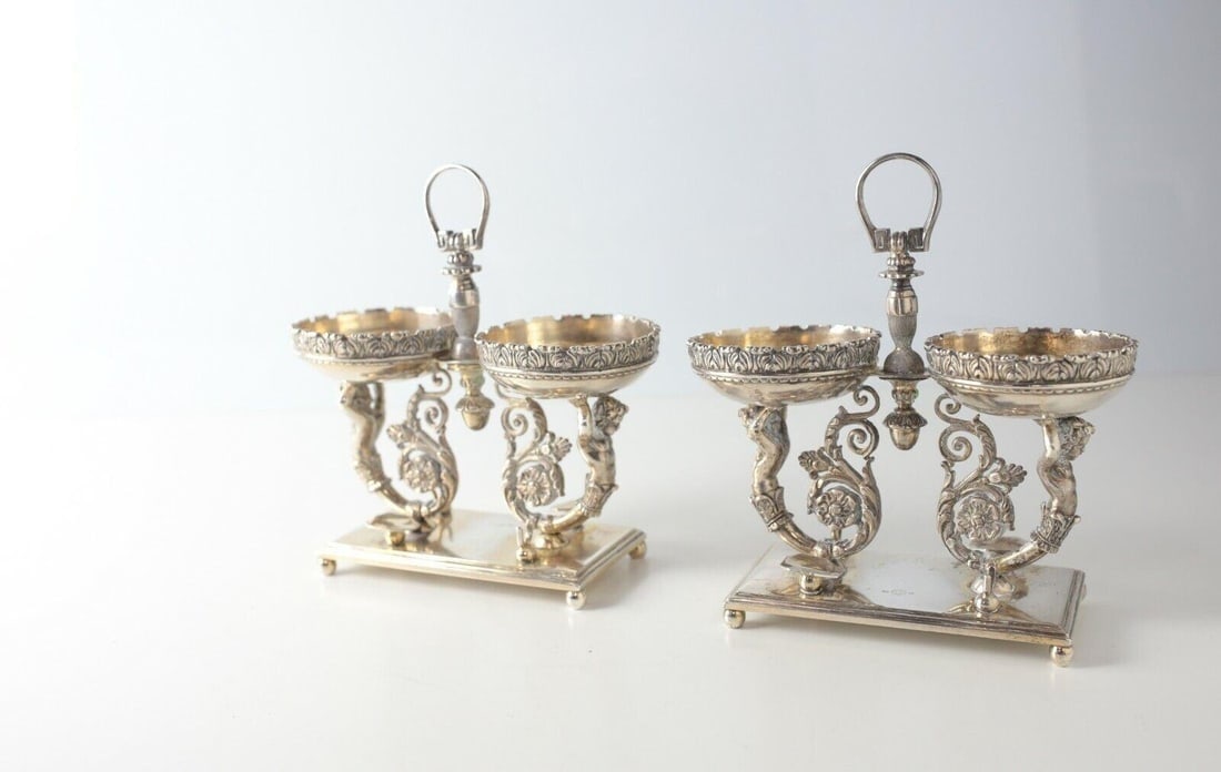 Pair Italian gilt 800 silver Open Master Salt Cellars spoon rest Messulam Milan: Pair of Italian gilt 800 silver Open Master Salt Cellars with spoon rest, Messulam Milano (1935-1970); each comprises two small open bowls, Pair of putti supports, on a rectangular base. A central fin