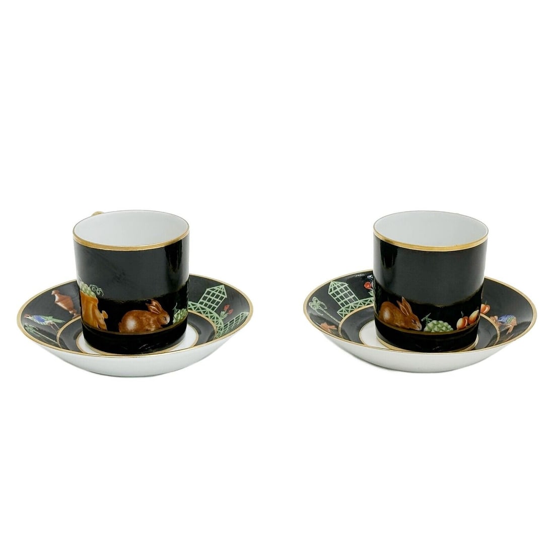 Pair Tiffany Le Tallec Private Stock Porcelain Cup & Saucers in Black Shoulder: Pair Tiffany Le Tallec Private Stock Porcelain Cup & Saucers in Black Shoulder. A black ground decorated with rabbits, birds, and fruits around the rim. Underside with Tiffany Private Stock marks. Wei