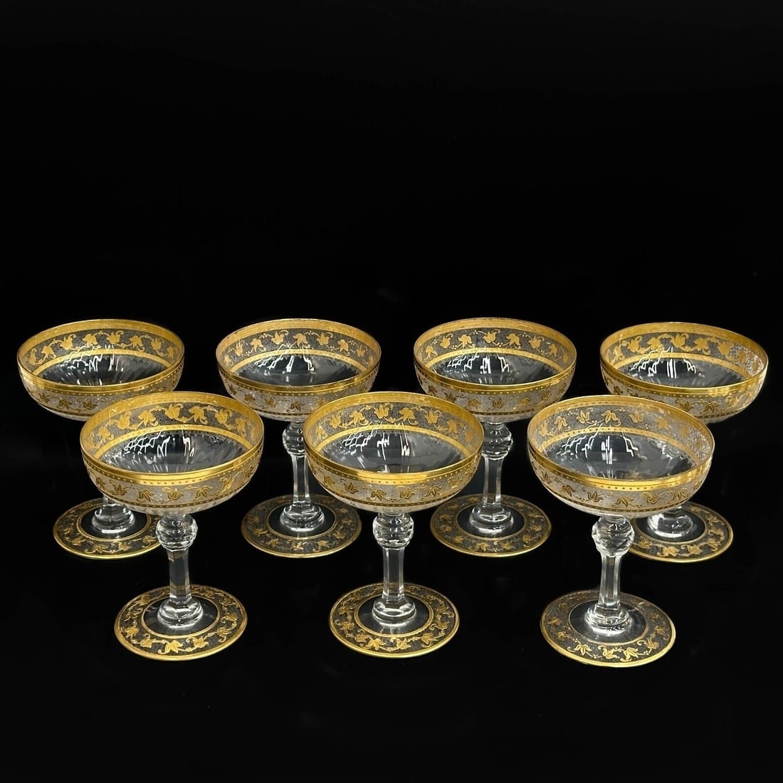 7 Saint (St) Louis France Glass Champagne Coupes Gilt Leaves: 7 Saint (St) Louis France Glass Champagne Coupes. Gilt leaf decoration to the rims, apparently unmarked. Weight: Approx. 2 lbs Measurements: Approx. 3.625 inches diameter x 4.5 inches Condition: Great