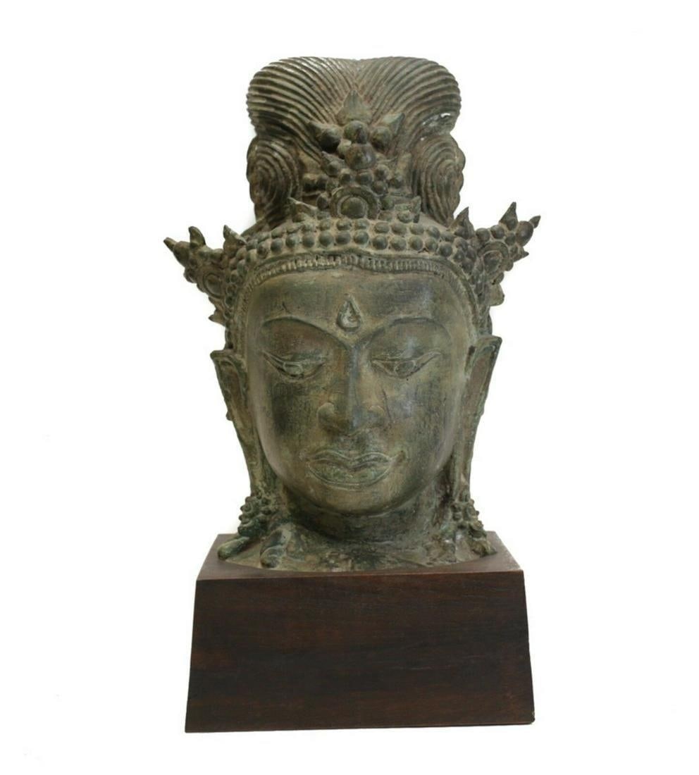 Large Bronze Head Fragment, Thai Buddhist Goddess, Tara / Guanyin Eyes downcast: Large Bronze Head Fragment, Thai Buddhist Goddess, Tara / Guanyin. Eyes downcast, chignon style hair. Three pronged crown. Green patina. Mounted on wood plinth. 18lbs. Measurements: Approx. 13.5" heig