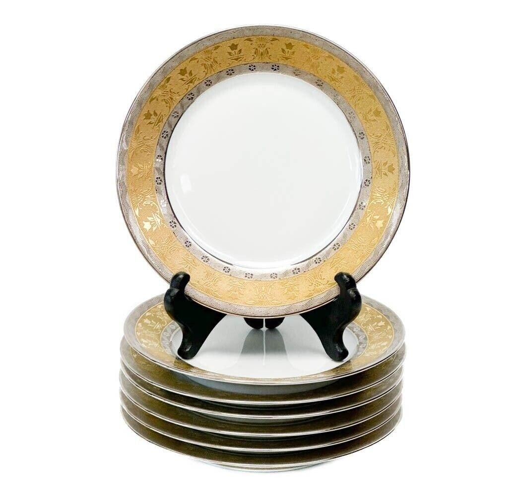 7 Christofle France Gilt & Platinum Banded Porcelain Bread Plates in La Paiva: 7 Christofle France porcelain bread plates in La Pavia. A white ground to center, gilt to the edge and with platinum bands to the rim with floral designs. Underside marked Pavillon Christofle La Paiva