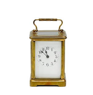 French Gilt Bronze & Glass Carriage Clock: French Gilt Bronze Carriage Clock. Gilt bronze carriage clock with carrying handle, glass panels to the sides. Back marked Made in France. Circa 1920. Weight Approx., 2 lbs. Measures Approx., 3.125 in