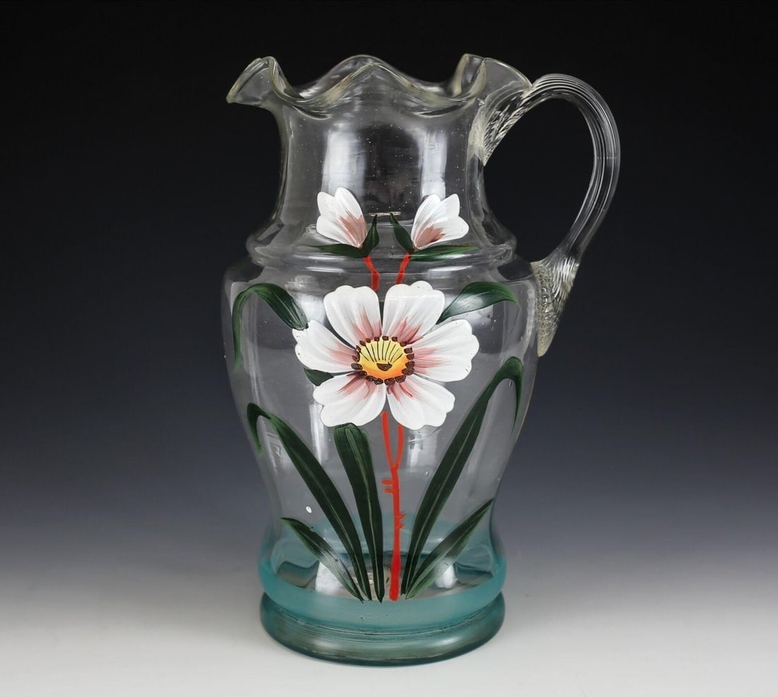 American Hand Blown Art Glass Pitcher, hand painted enamel flower, Mid century: American Hand Blown Art Glass Pitcher, hand painted enamel flower. Mid century Ruffled rim, reeded handle. 2lbs Measurements: Approx. 11inches height x 7.5inches spout to handle x 5.75inches diameter