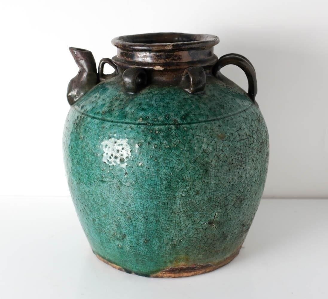 Chinese Martaban Earthenware Wine or Oil Storage Jar: Chinese Martaban Earthenware Wine or Oil Storage Jar. Green glaze, loops and spout. Bright deep blue green glaze with overall crazing. Approx 8.4lb. Approx 10.5 in height x 9 in diameter Domestic Ship