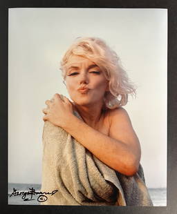 Color Photograph Marilyn Monroe by George Barris: A limited edition George Barris photograph of Marilyn Monroe. Signed by George Barris in marker (lower left). Stamped and numbered on reverse. Marilyn Monroe at Santa Monica Beach in 1962, holding a t