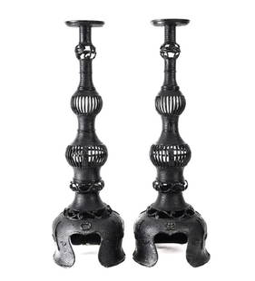 Pair of Old Chinese Iron Candlesticks: A large pair of old Chinese iron candlesticks, with open wire work, painted in black. Raised on three feet. From a prominent Sherman Oaks Estate that started purchasing in the 1940s. Measures: 17.5 in