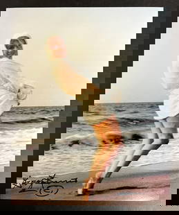 Color Photograph Marilyn Monroe by George Barris: A limited edition George Barris photograph of Marilyn Monroe. Signed by George Barris in marker (lower left). Stamped and numbered on reverse. Marilyn Monroe at Santa Monica Beach in 1962, dressed in