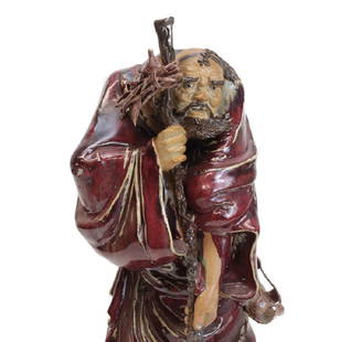 Large Chinese Shiwan Pomegranate red Pottery Stoneware: Large Chinese Shiwan Pomegranate red Pottery Stoneware Figurine Deity Luohan figure. Character has expressive countenance, hunched shoulders, his straw sandals strapped to his side. Holds a crooked st