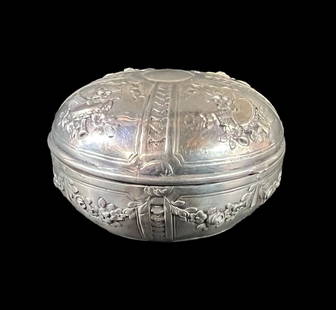 Storck & Sinsheimer German Hanau 800 Silver box c1875: Storck & Sinsheimer German Hanau 800 Silver Box, c1875. Repousse musical instruments, floral swags. Hallmarks on the base. Measurements: Approx. 121grams. 3.125 in diameter x 2 inches Condition: Overa