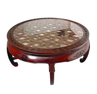 A Chinese hardwood coffee table: A Chinese hardwood coffee table, Mid/late 20th century. Marked on metal plaque: J. L. George & Co. / 3 Cameron Rd. / Kowloon / Made in Hong Kong The carved wood table with reticulated lattice top surm