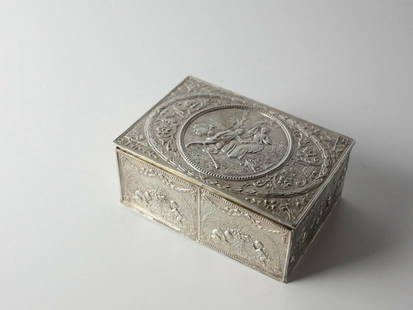 J.D. Schleissher & Sohne German Hanau 800 Silver Box c1890: J.D. Schleissher & Sohne German Hanau 800 Silver Box c1890, gilt interior. Hand chased scenes, courting couple on top, cherubs on the sides, with swags, urns and floral motifs. Makers mark on base Mea