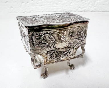 German Hanau Miniature Silver side table Friedrich Reusswig 1903-1926: German Hanau Miniature Silver side table, Friedrich Reusswig 1903-1926 hand chased designs featuring scrolls and florals, false front drawers. Hinged table top, gilt interior. Weight: Approx. 41.36 gr