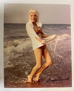 Color Photograph Marilyn Monroe by George Barris: A limited edition George Barris color photograph of Marilyn Monroe. Signed by George Barris in marker (lower right). Stamped and numbered on reverse. Marilyn Monroe at Santa Monica Beach in 1962, dres