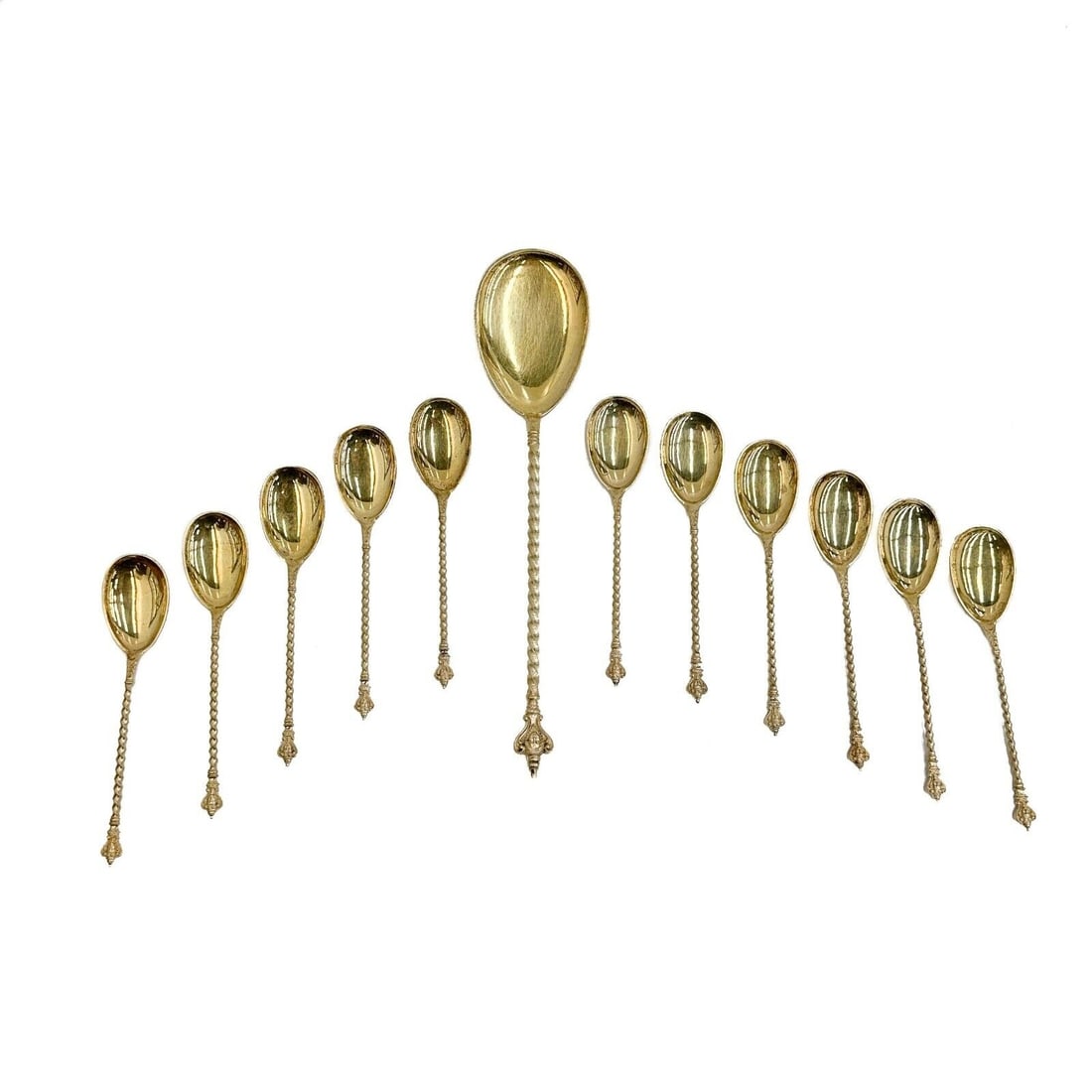 Bruckmann & Sohne German Gilt 800 Silver Berry or Ice Cream Spoon Serving Set: Bruckmann & Sohne German Gilt 800 Silver Berry or Ice Cream Spoon Serving Set, circa 1900. Includes one serving spoon and 11 spoons. Twisted handles, figural face to the end. Underside of handle marke