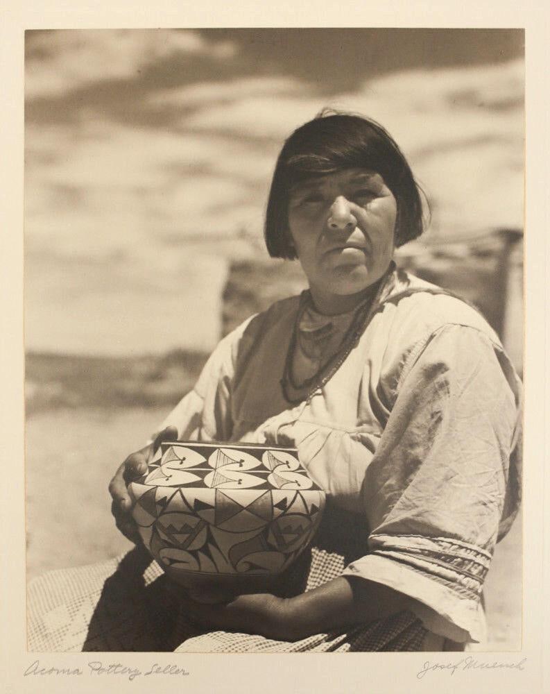 Muench, Josef 1904-1998 B/W Gelatin Silver Photograph, 'Acoma Pottery Seller'.: Muench, Josef (1904-1998) B/W Gelatin Silver Photograph, 'Acoma Pottery Seller'. Seated woman holding pot. Signed in Pencil 'Josef Muench' lower right on mat board. artist's stamp on reverse. Weight: