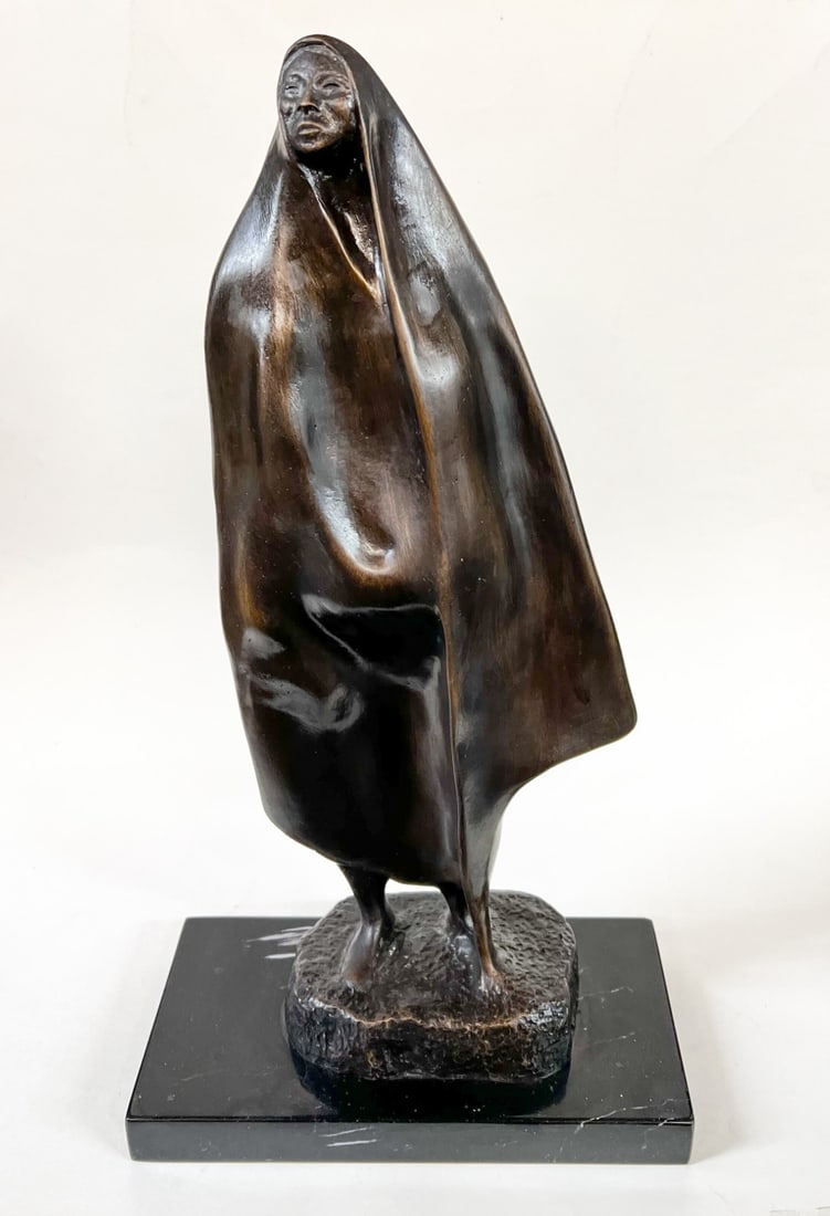 Francisco Zuniga Bronze sculpture: after Francisco Zuniga (Mexican 1912-1998) Bronze sculpture, signed at the base, un-numbered. standing figure draped in a rebozo. On black stone plinth. 8.3lbs Measurements: Approx. bronze 14 inches h