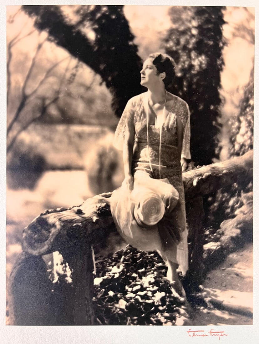 Elmer Fryer Sepia Tone photograph of Actress Billie Dove c1930: Elmer Fryer (American 1898-1944) Sepia Tone silver gelatin photograph, Film actress Billie Dove, seated on a log; signed lower right on board the photo is mounted to. (D2) Iconic Hollywood photographe