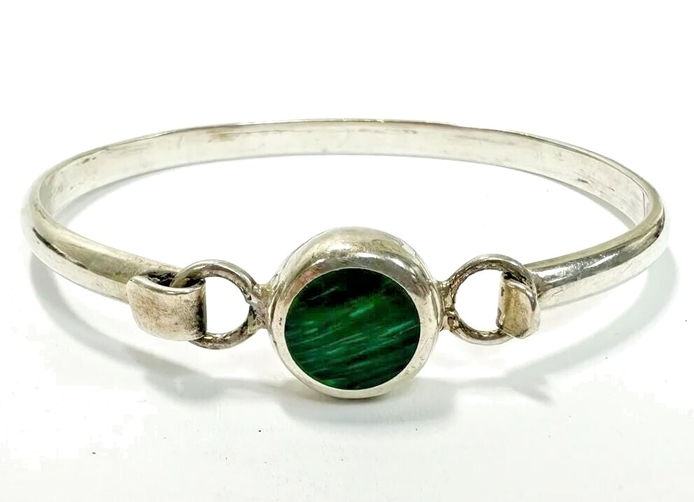 Vintage Mexico 925 Sterling Silver and Malachite Bangle Bracelet: Mexico 925 Sterling Silver and Green Malachite Bangle Bracelet. Round cut malachite flush gemstone to center. Marked 'Mexico 925' to interior. Hook closure in front. Measurements: Approx. 16.71 grams;