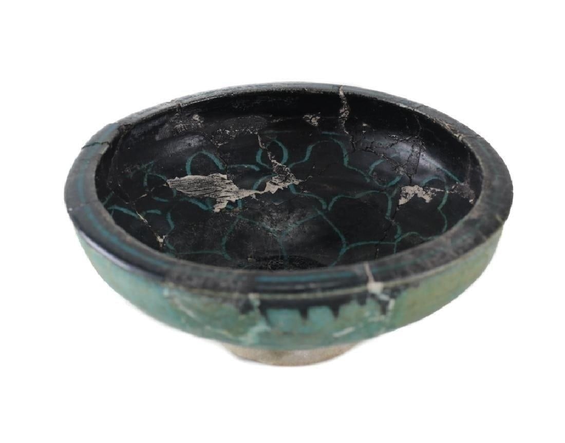 Archaic bowls Kashan Pottery Bowl Syria: Archaic bowls Kashan Pottery Bowl restored, Syria 12-13th century. Turquoise on the outside, black with floral design on interior. Unmarked. Approx 1.2lb Approx. 8.125 inches diameter x 3.5 inches hei