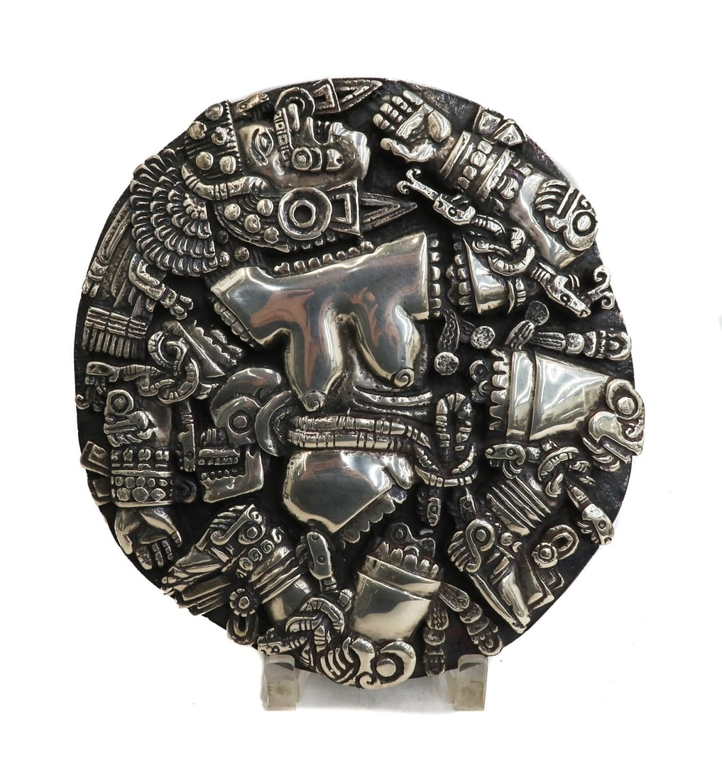 Silverplate Aztec Coyolx?uhqui Relief Plaque: Silverplate Aztec Coyolx?uhqui Relief Plaque. The plaque depicts Coyolx?uhqui "Painted with Bells", an Aztec goddess of the Moon or Milky Way and symbolizes the cross between the sun and moon. Weight:
