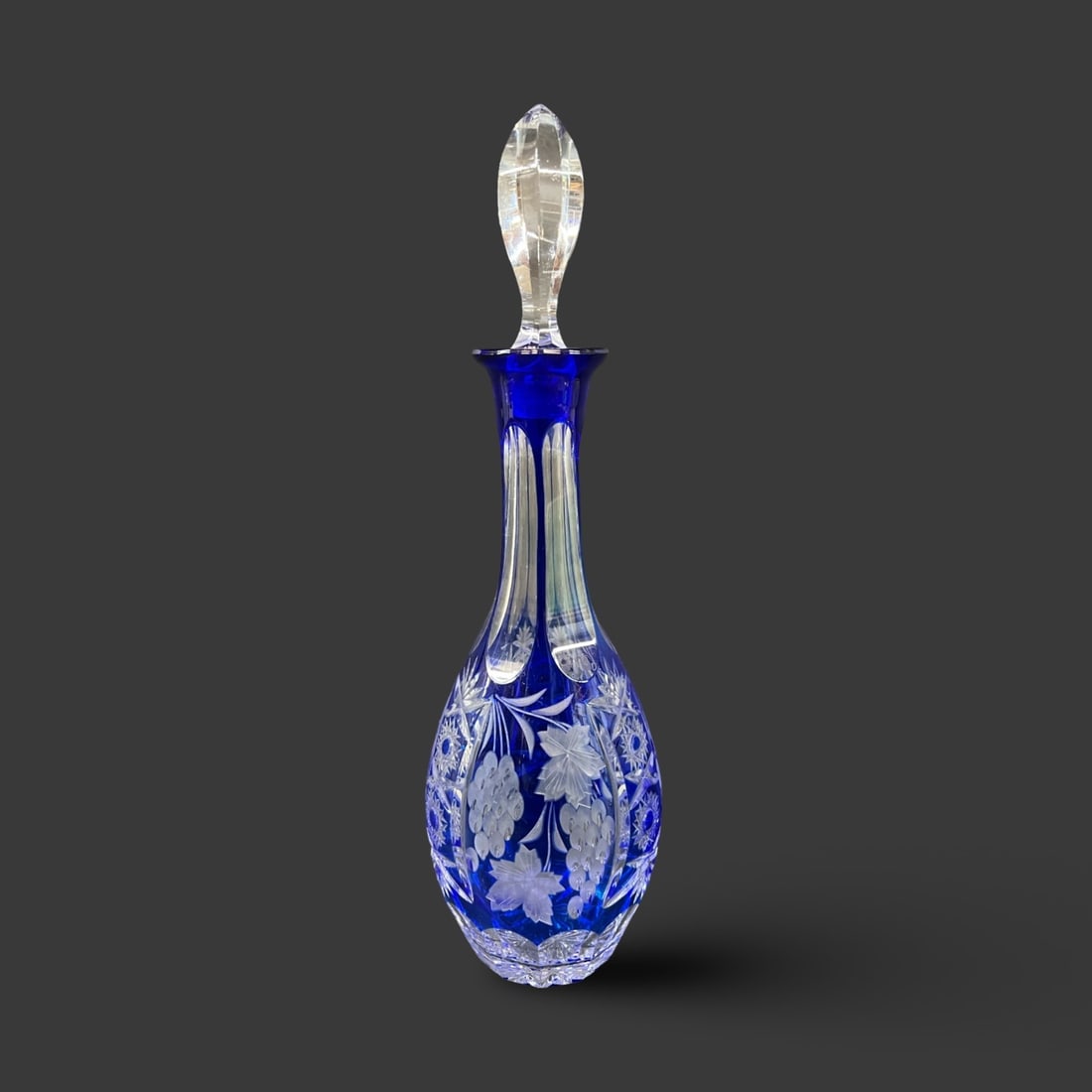 Nachtmann Traube Cobalt Blue Cut to clear Crystal Wine Decanter: Nachtmann Traube Cobalt Blue Cut to clear Crystal Wine Decanter, with flame form stopper. Grape and ivy motifs. Unmarked. 2lbs Measurements: Approx. 12.25 inches total height Condition: Great conditio