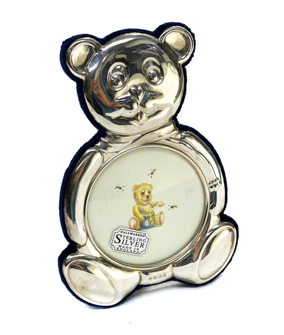 Carr's of Sheffield Ltd. Sterling Silver Teddy Bear Photo Frame, 1997: Carr's of Sheffield Ltd. sterling silver teddy bear photo frame, 1997. A drawing of a bear eating honey to the center. With original sticker. Cobalt blue fabric to the backing. Carr's of Sheffield Ltd